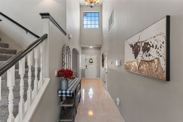 a view of a hallway with wooden floor and stairs