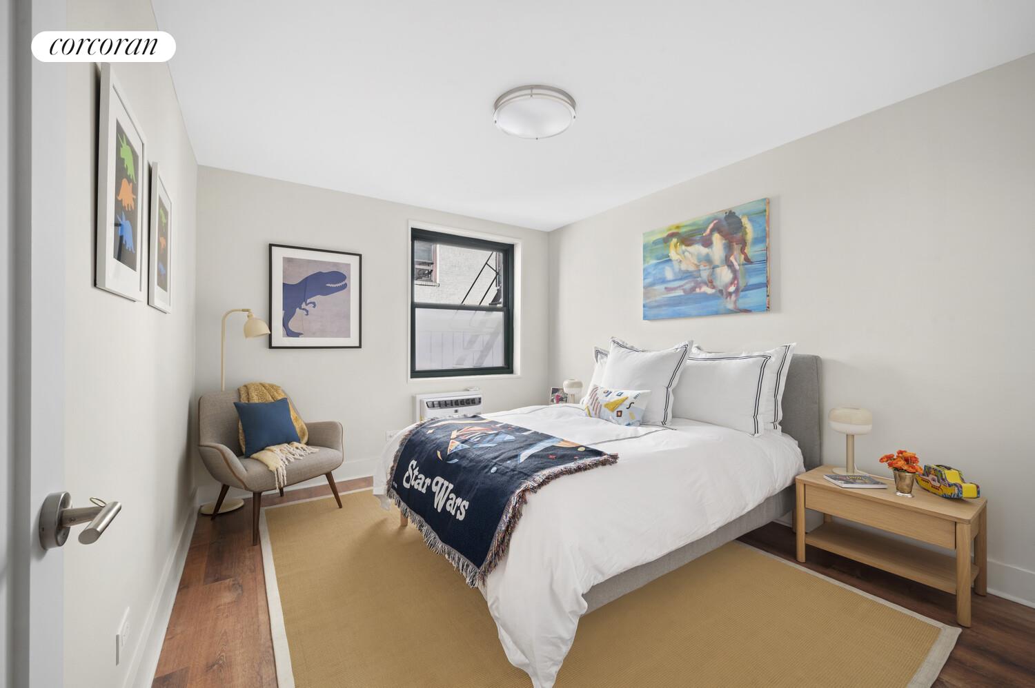 636 Washington Street, Unit 3B Manhattan, NY 10014 - Photo 6 of 9 a bedroom with a bed and wooden floor