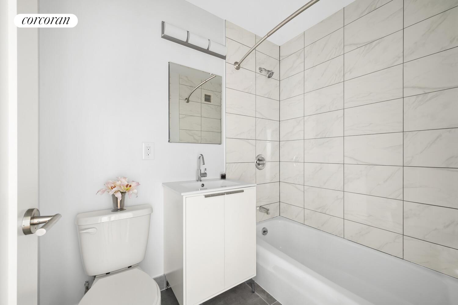 636 Washington Street, Unit 3B Manhattan, NY 10014 - Photo 7 of 9 a bathroom with a bathtub shower sink mirror and toilet