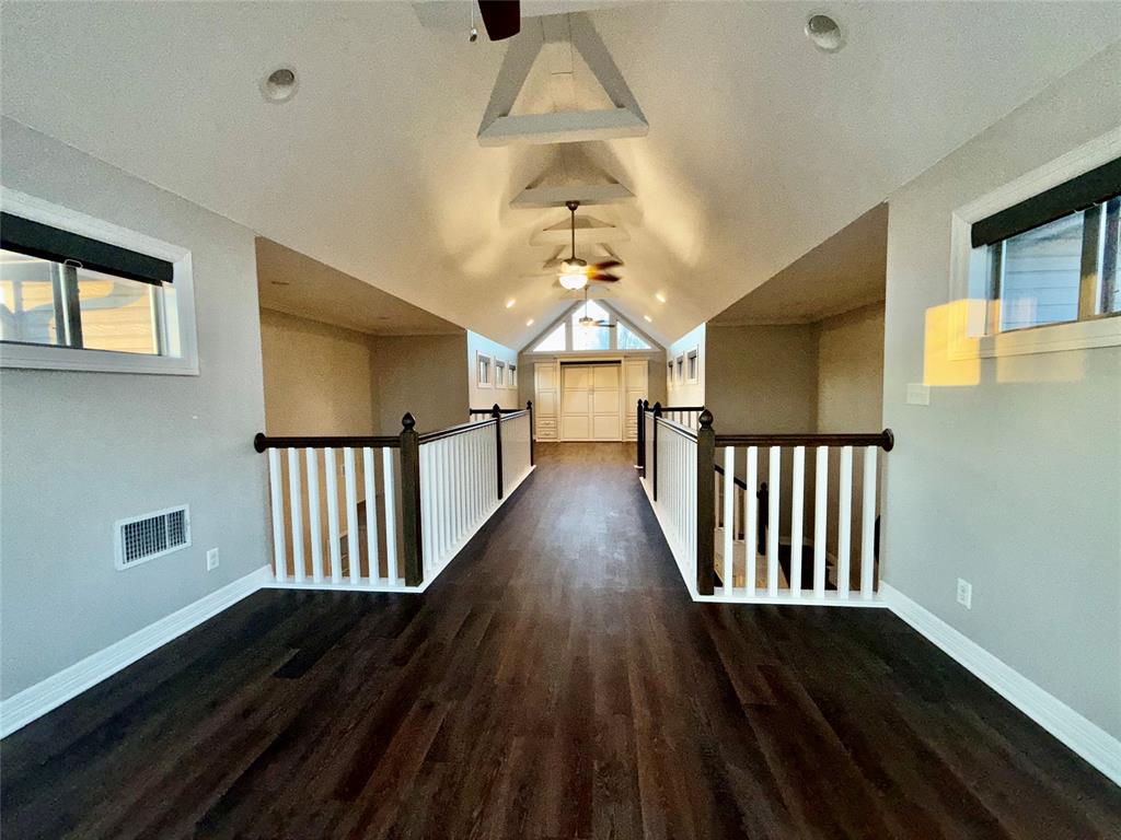 3815 Holly Ridge Drive, Unit GUEST Longview, TX 75605 - Photo 11 of 31 Hallway with dark wood-type flooring and baseboards