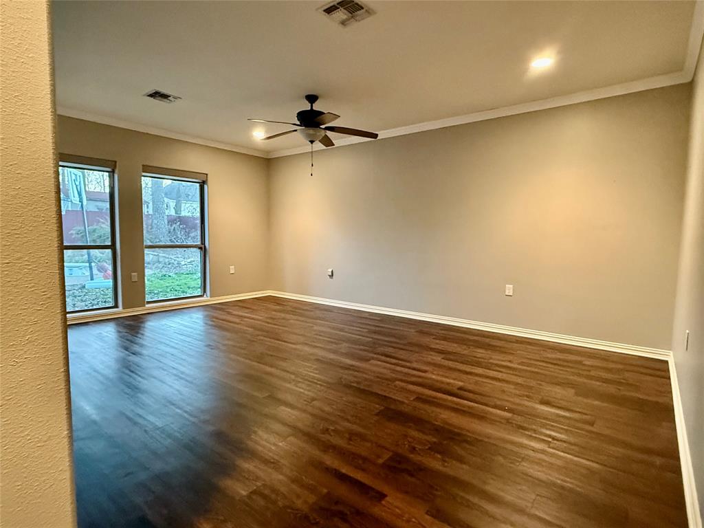 3815 Holly Ridge Drive, Unit GUEST Longview, TX 75605 - Photo 14 of 31 Spare room featuring dark wood finished floors, ceiling fan, crown molding, and recessed lighting