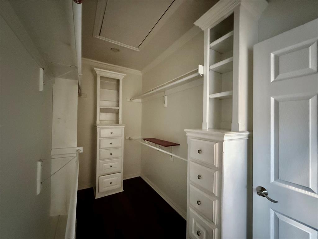 3815 Holly Ridge Drive, Unit GUEST Longview, TX 75605 - Photo 15 of 31 Walk in closet with attic access and dark wood-type flooring