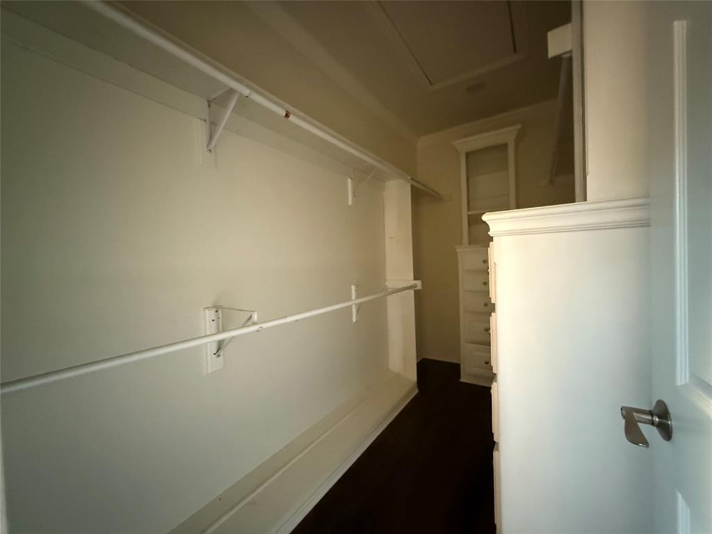 3815 Holly Ridge Drive, Unit GUEST Longview, TX 75605 - Photo 16 of 31 Walk in closet featuring attic access