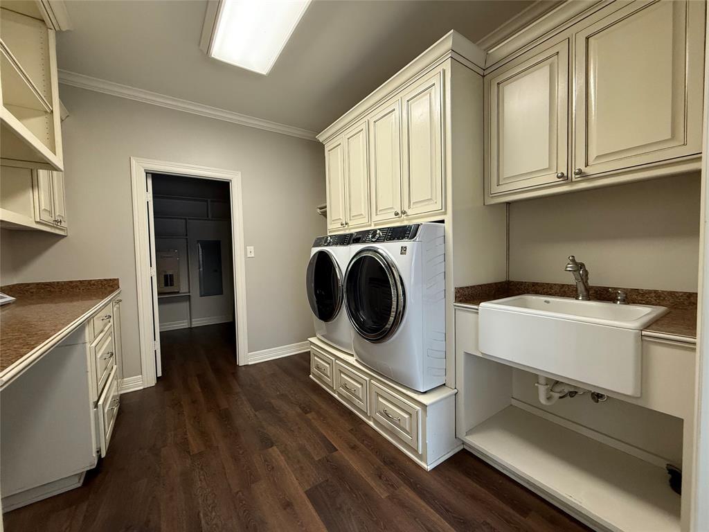 3815 Holly Ridge Drive, Unit GUEST Longview, TX 75605 - Photo 20 of 31 Laundry area with ornamental molding, dark wood finished floors, separate washer and dryer, and cabinet space