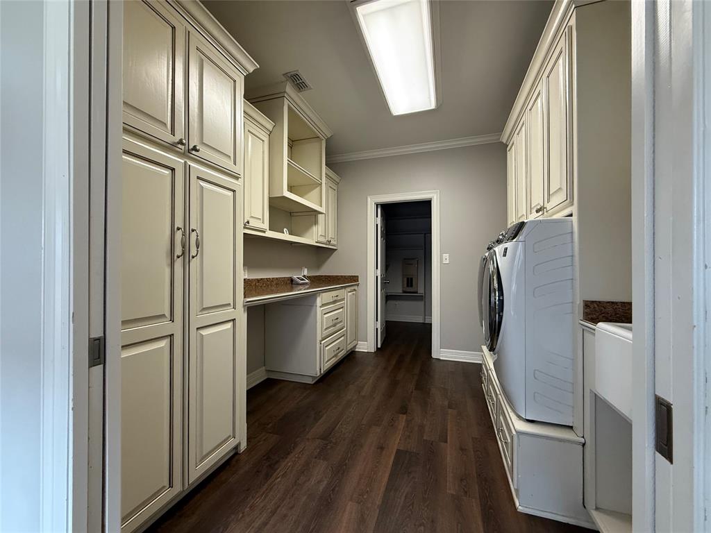 3815 Holly Ridge Drive, Unit GUEST Longview, TX 75605 - Photo 21 of 31 Laundry area with an office area, crown molding, dark wood-style flooring, cabinet space, and washing machine and clothes dryer