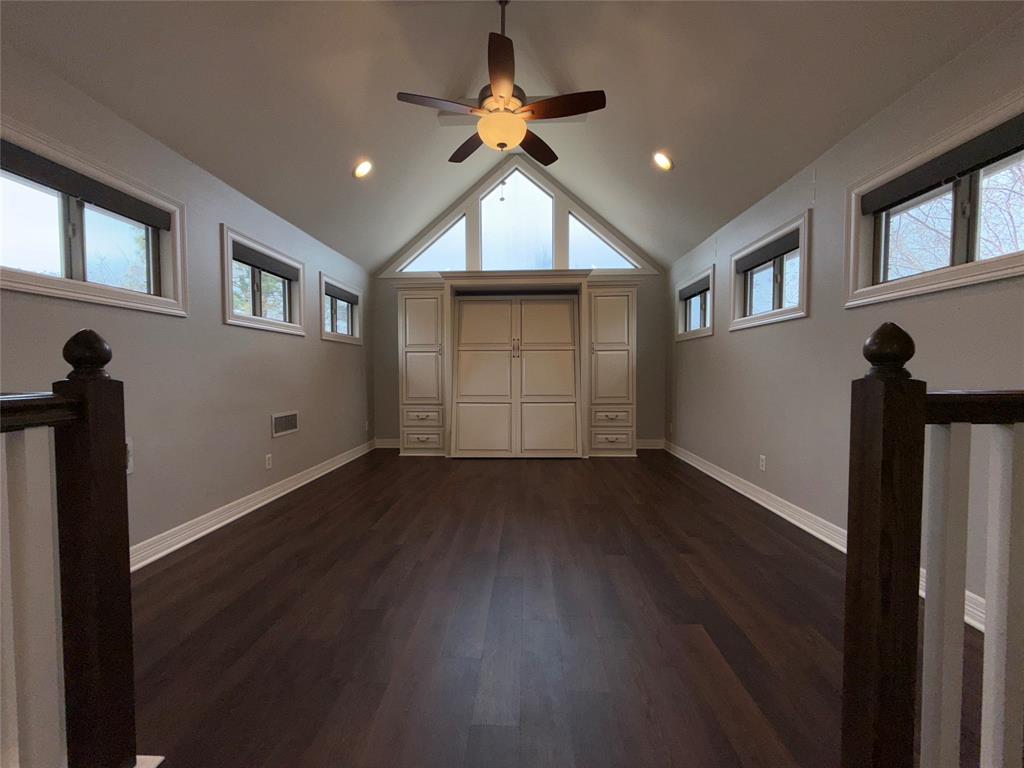 3815 Holly Ridge Drive, Unit GUEST Longview, TX 75605 - Photo 24 of 31 Unfurnished bedroom featuring dark wood finished floors, multiple windows, a ceiling fan, and recessed lighting