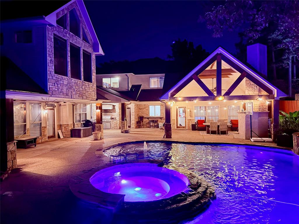 3815 Holly Ridge Drive, Unit GUEST Longview, TX 75605 - Photo 29 of 31 Pool at twilight with a patio, a pool with connected hot tub, and grilling area