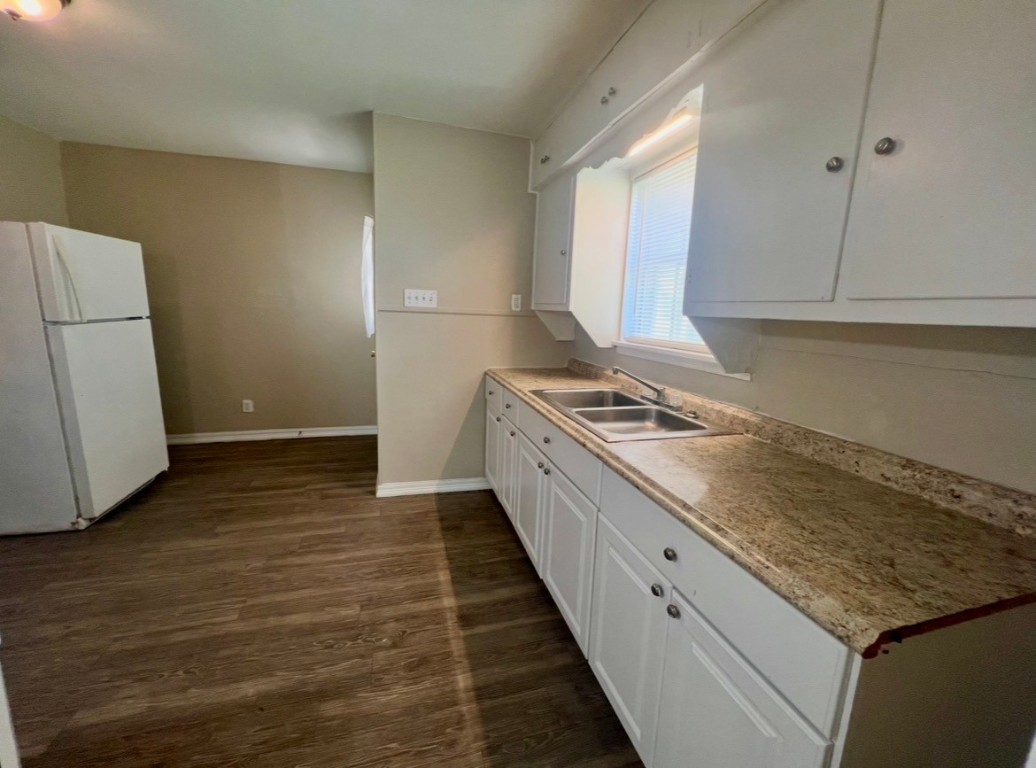 415 Randall Street Pasadena, TX 77506 - Photo 3 of 13 a kitchen with granite countertop white cabinets and white appliances