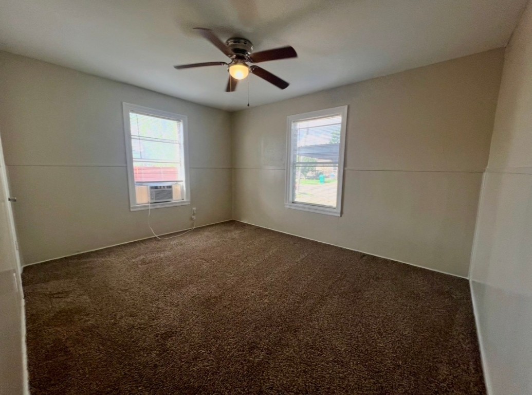 415 Randall Street Pasadena, TX 77506 - Photo 8 of 13 an empty room with windows and fan