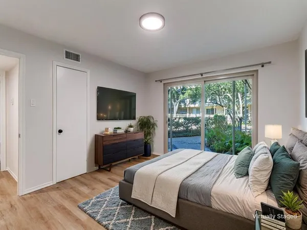 a bedroom with a bed and a flat screen tv