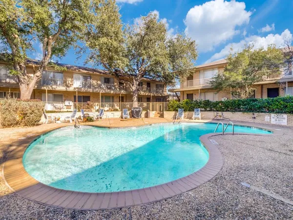 a view of a swimming pool with a patio
