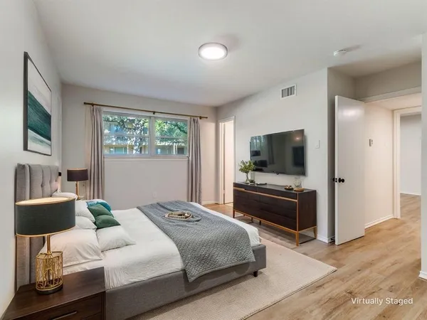 a bedroom with a bed and a flat screen tv