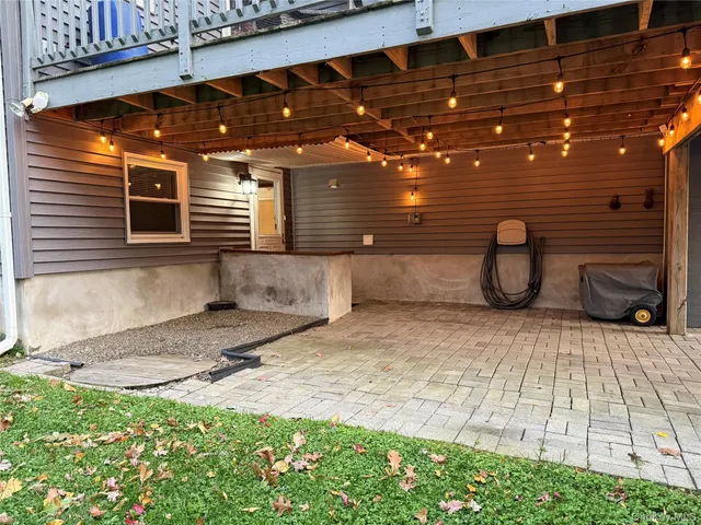 a backyard of a house with barbeque oven