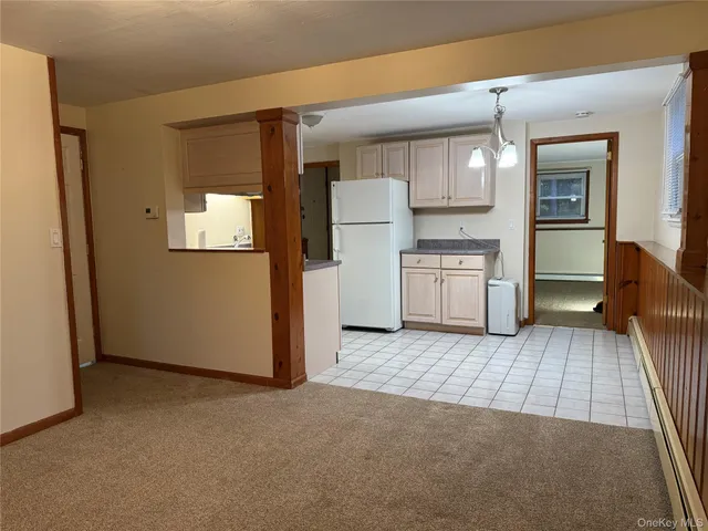 an empty room with a fireplace and wooden floor