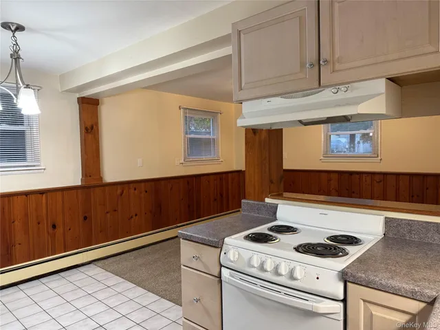 a kitchen with granite countertop cabinets and white appliances