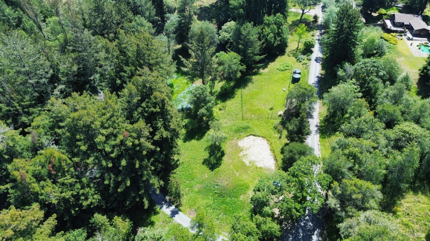 an aerial view of a house with a yard
