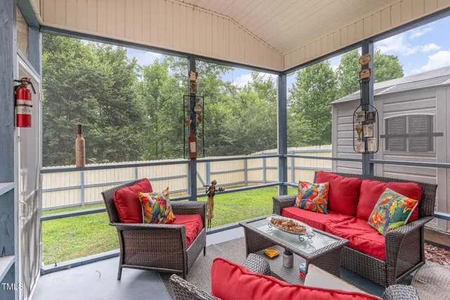 a living room with furniture and a floor to ceiling window