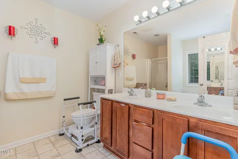 a bathroom with a sink vanity mirror and toilet