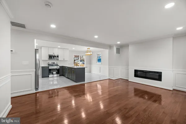 a view of a livingroom with an empty space and a fireplace