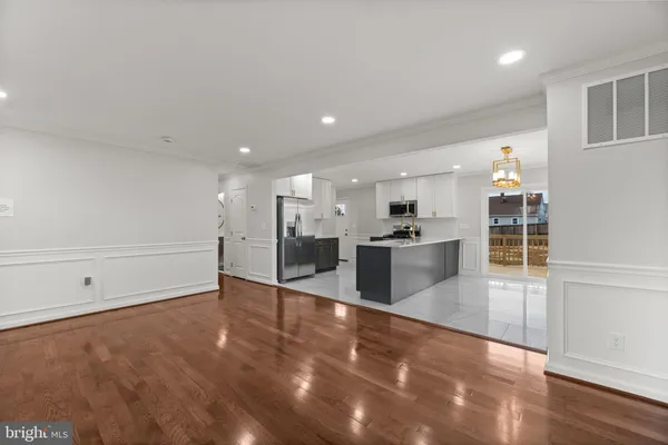 an empty room with wooden floor and white walls