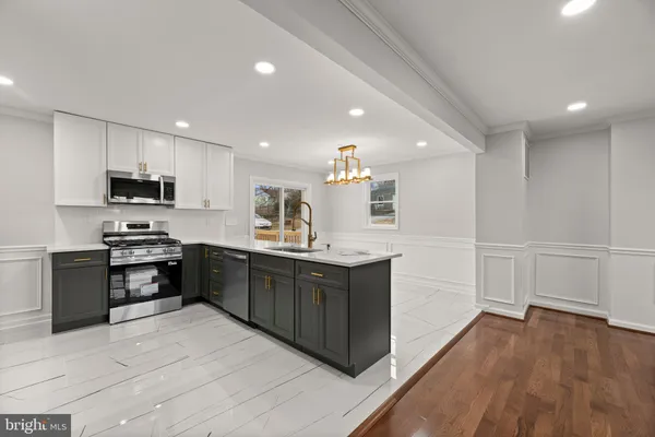 a large kitchen with stainless steel appliances lots of counter top space