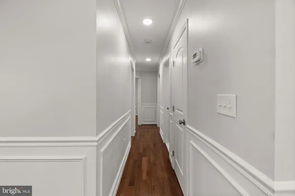 a bathroom with a toilet sink vanity and mirror