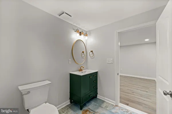 a white toilet sitting next to a bathroom sink
