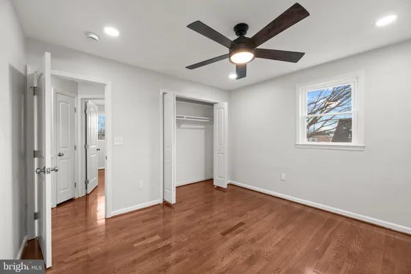 a view of a room with wooden floor and window