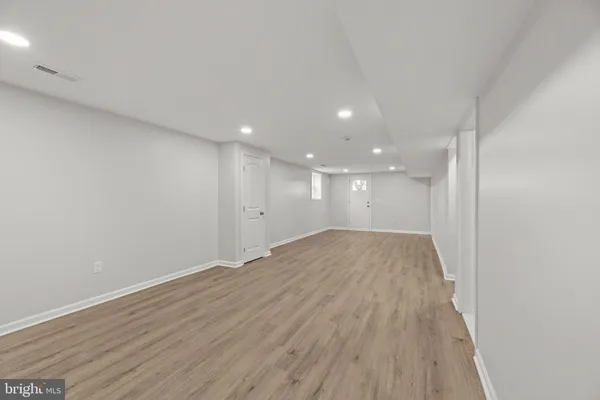a view of room with window and wooden floor