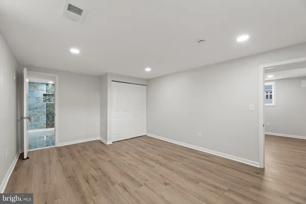 a view of an empty room with wooden floor