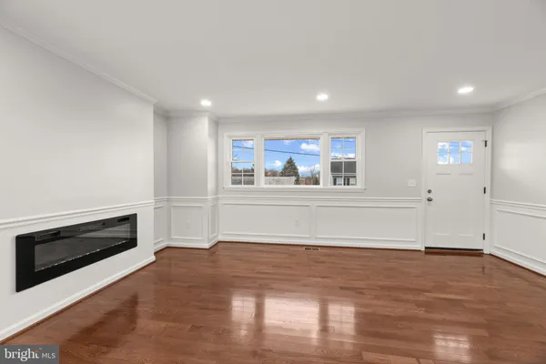 a view of a livingroom with an empty space and a fireplace