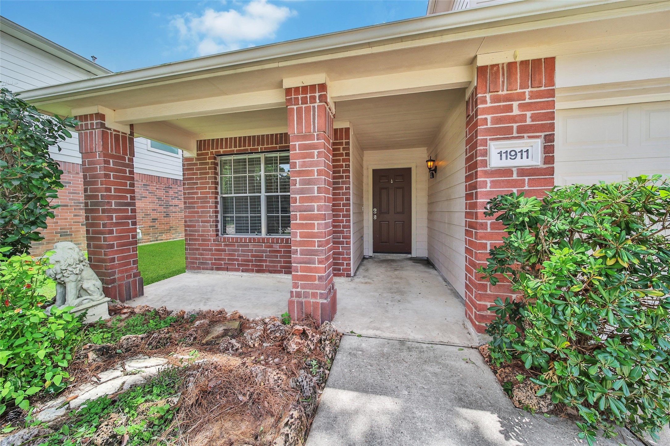 This property features a covered front porch and a two car attached garage.