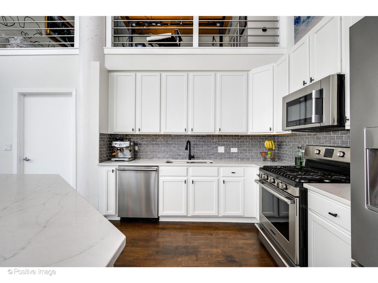 909 West Washington Boulevard, Unit 1012 Chicago, IL 60607 - Photo 12 of 30 a kitchen with stainless steel appliances granite countertop a stove a sink and a microwave