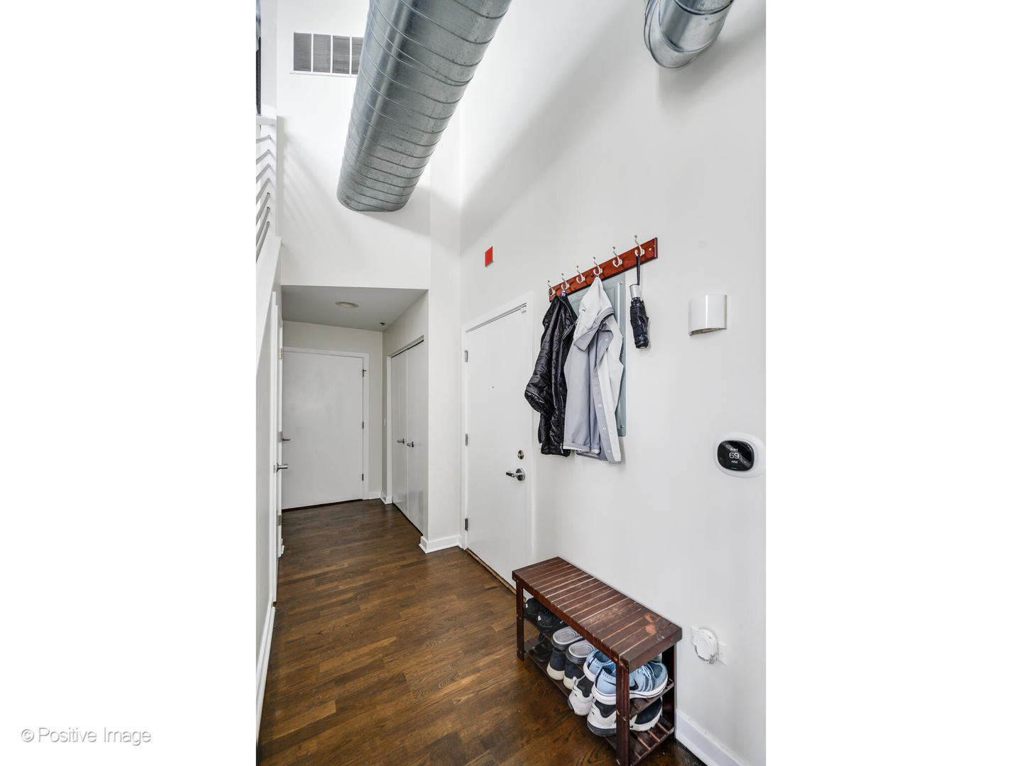 909 West Washington Boulevard, Unit 1012 Chicago, IL 60607 - Photo 23 of 30 a view of a hallway with wooden floor