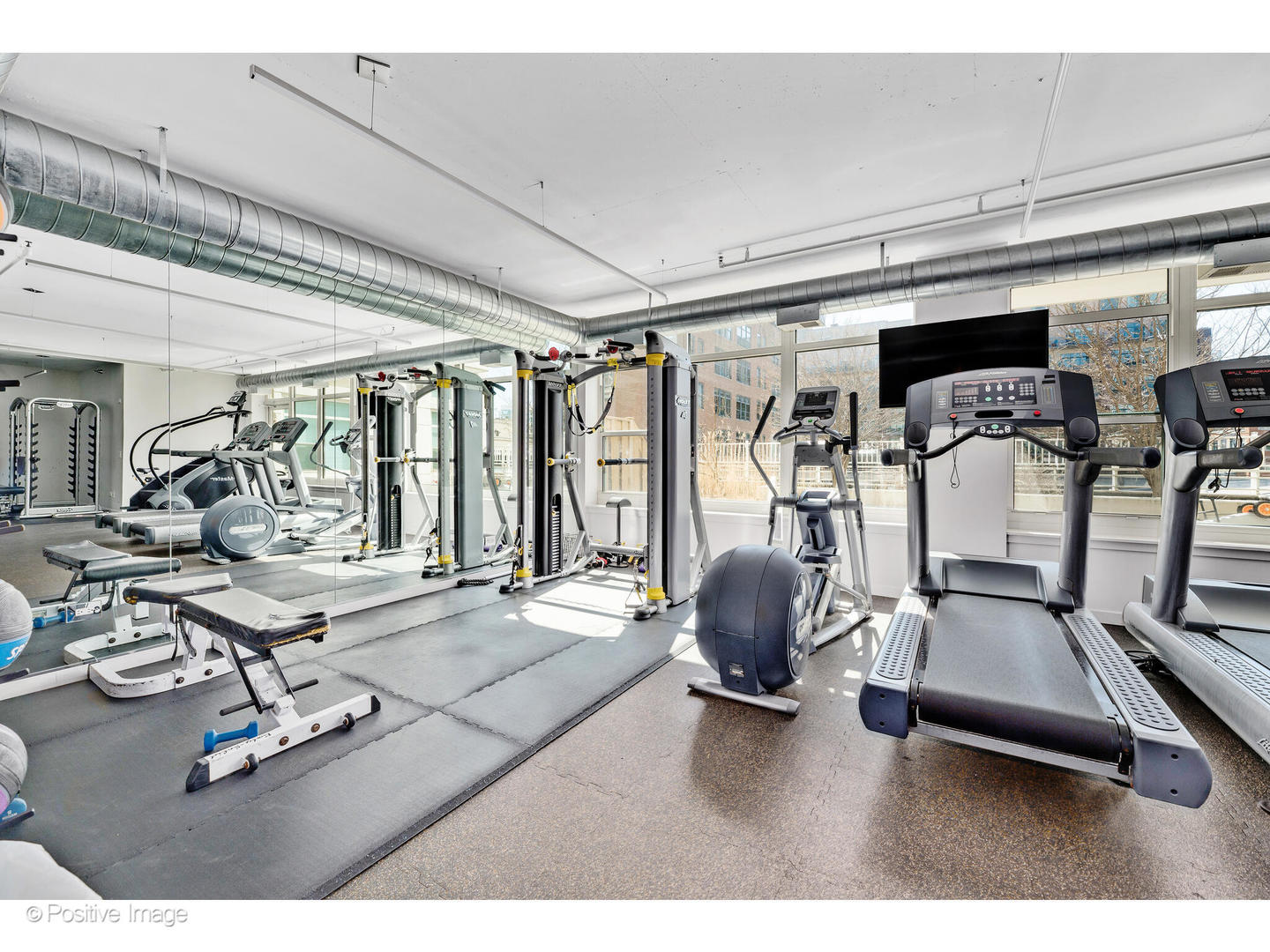 909 West Washington Boulevard, Unit 1012 Chicago, IL 60607 - Photo 26 of 30 a room with gym equipment and large mirror