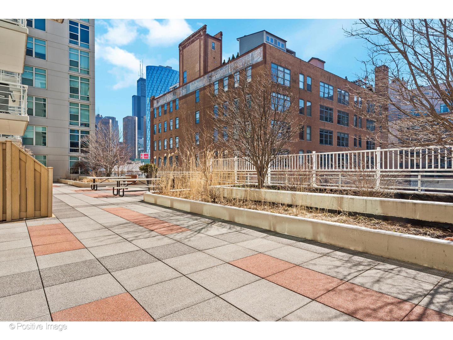 909 West Washington Boulevard, Unit 1012 Chicago, IL 60607 - Photo 28 of 30 a view of a brick building next to a yard