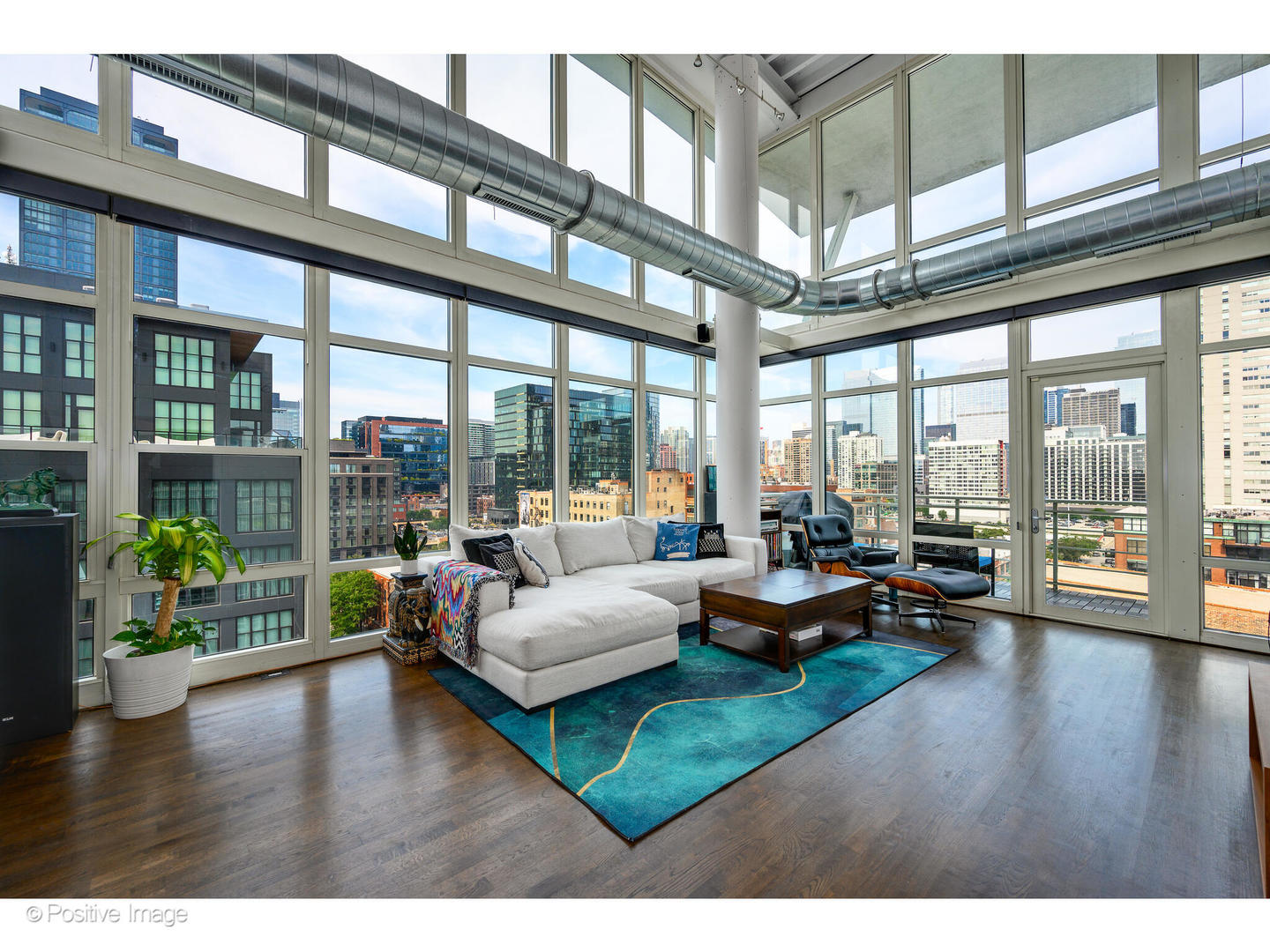 909 West Washington Boulevard, Unit 1012 Chicago, IL 60607 - Photo 3 of 30 a living room with furniture and floor to ceiling windows