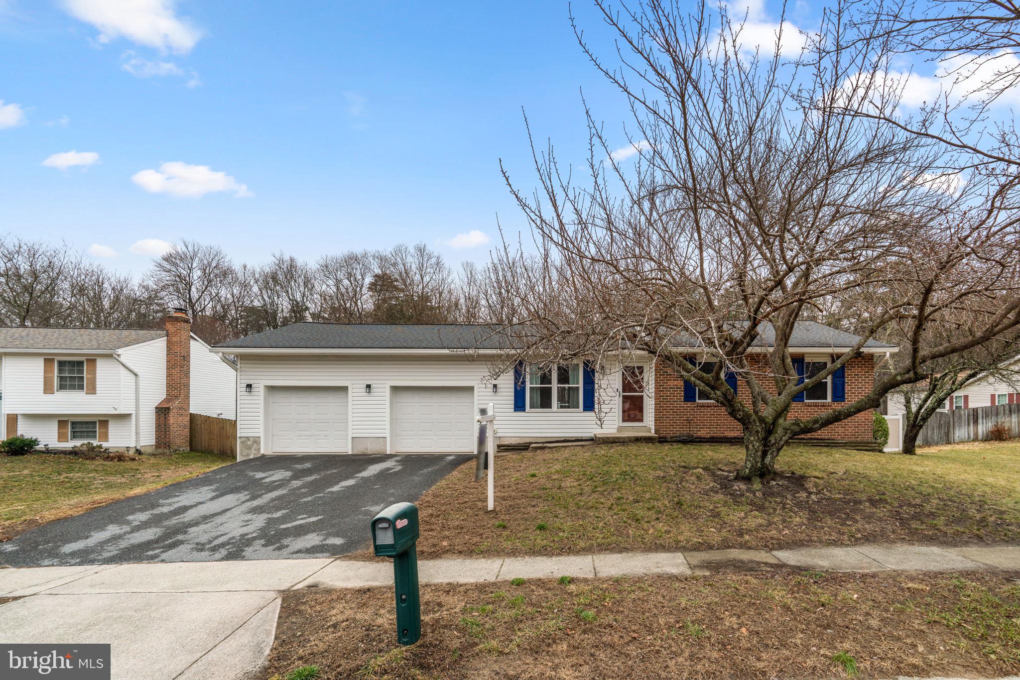 7818 Metacomet Road Hanover, MD 21076 - Photo 1 of 52 a front view of a house with a yard and large tree