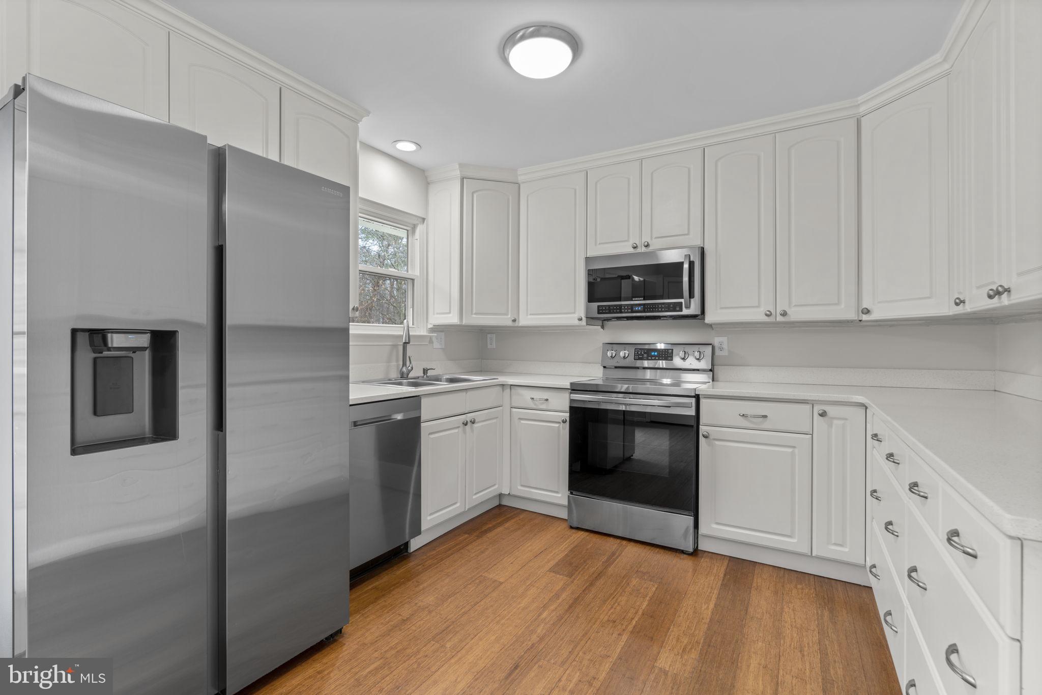 7818 Metacomet Road Hanover, MD 21076 - Photo 11 of 52 a kitchen with granite countertop white cabinets and stainless steel appliances