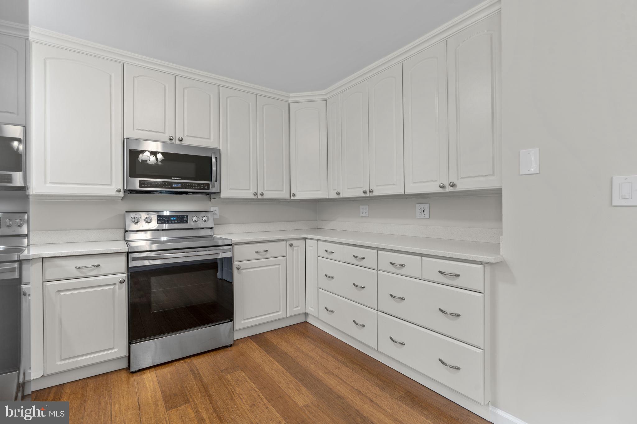 7818 Metacomet Road Hanover, MD 21076 - Photo 13 of 52 a kitchen with granite countertop white cabinets and stainless steel appliances