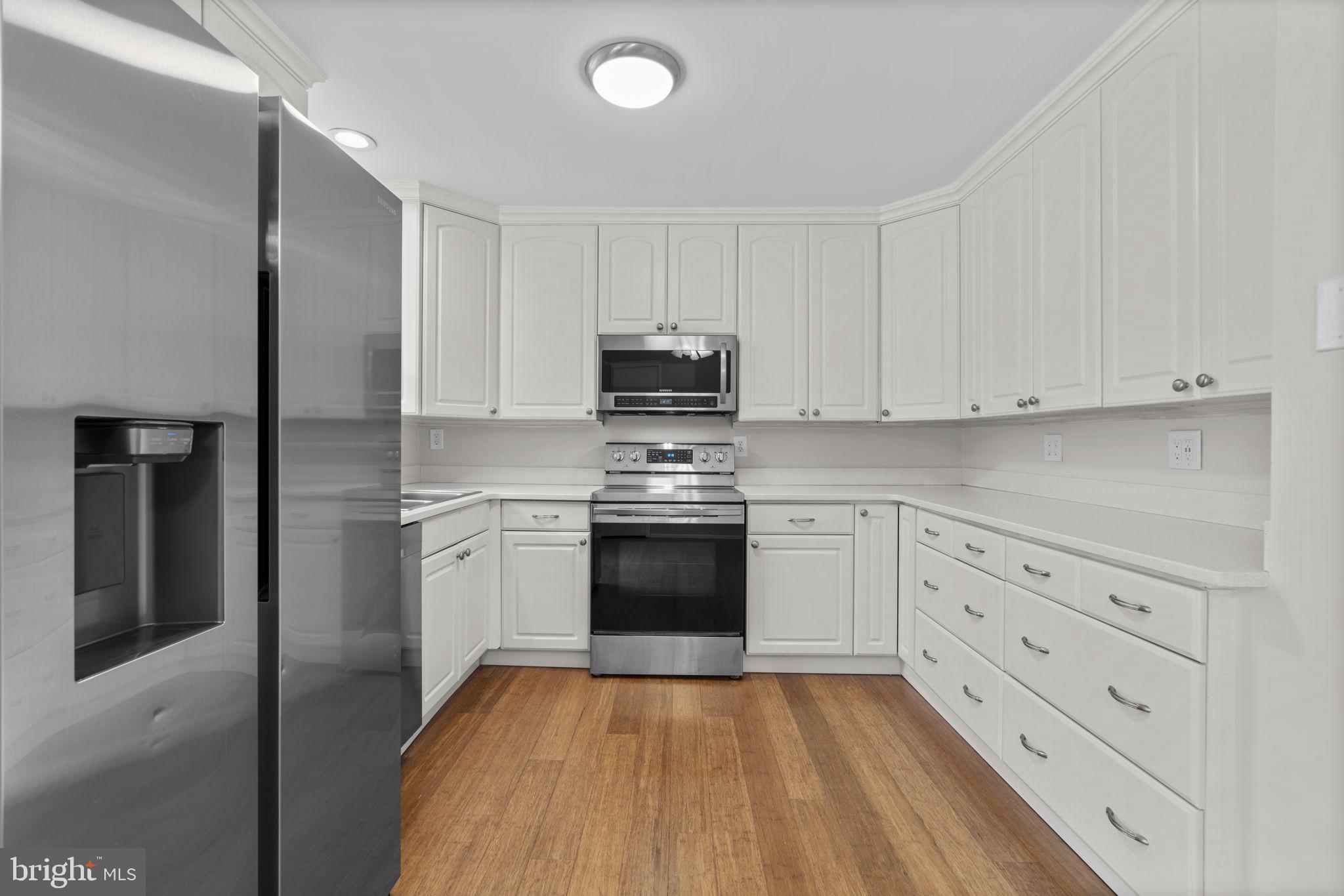 7818 Metacomet Road Hanover, MD 21076 - Photo 14 of 52 a kitchen with granite countertop white cabinets and stainless steel appliances