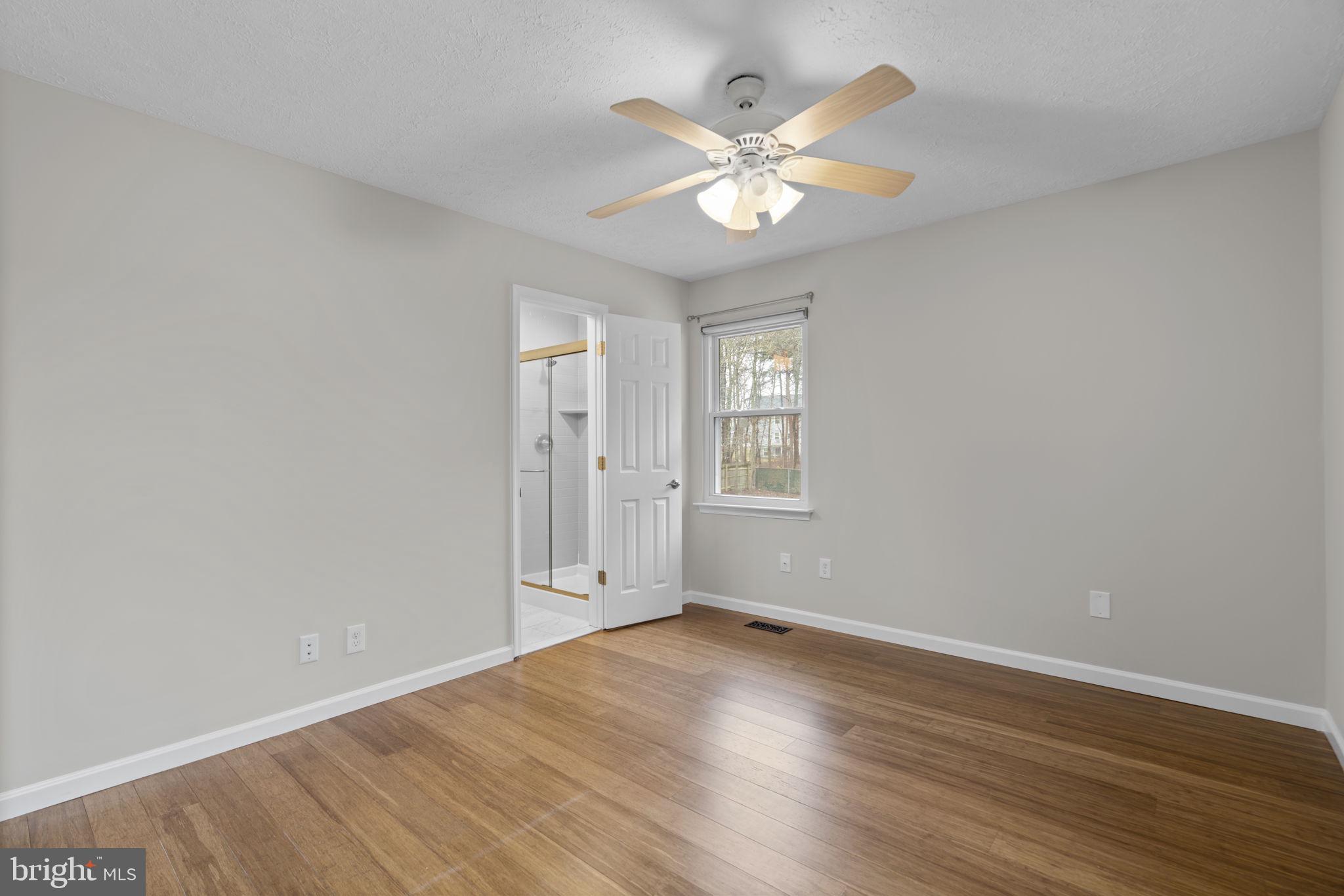 7818 Metacomet Road Hanover, MD 21076 - Photo 19 of 52 wooden floor in an empty room with a window