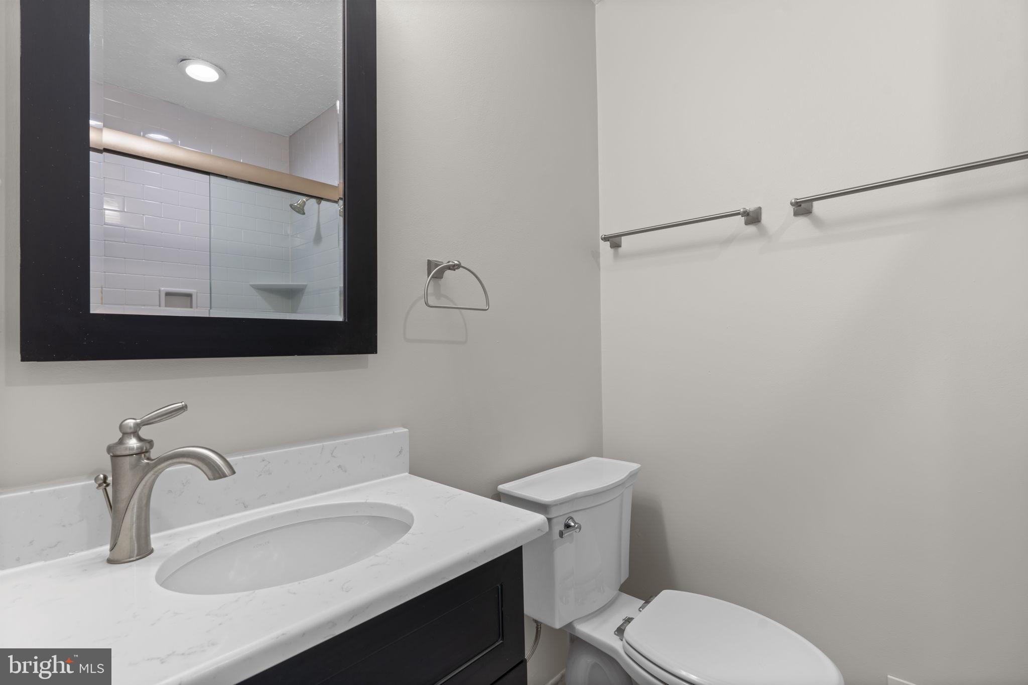 7818 Metacomet Road Hanover, MD 21076 - Photo 21 of 52 a bathroom with a sink toilet and mirror