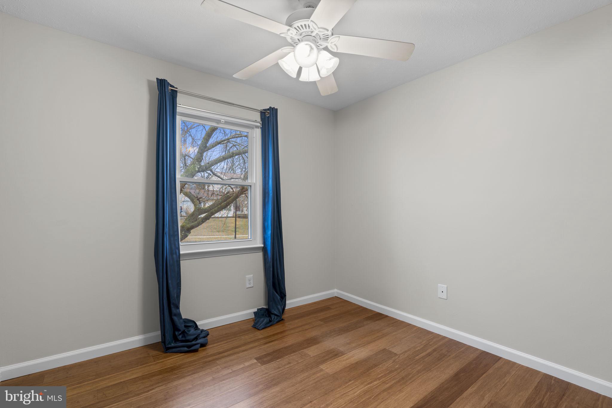 7818 Metacomet Road Hanover, MD 21076 - Photo 24 of 52 a view of an empty room with wooden floor and a window