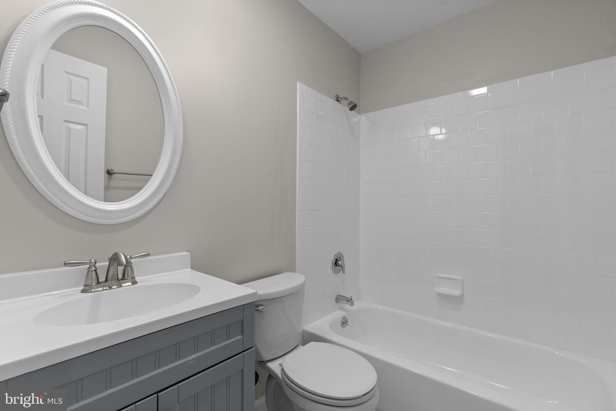 7818 Metacomet Road Hanover, MD 21076 - Photo 26 of 52 a bathroom with a sink toilet a mirror and shower