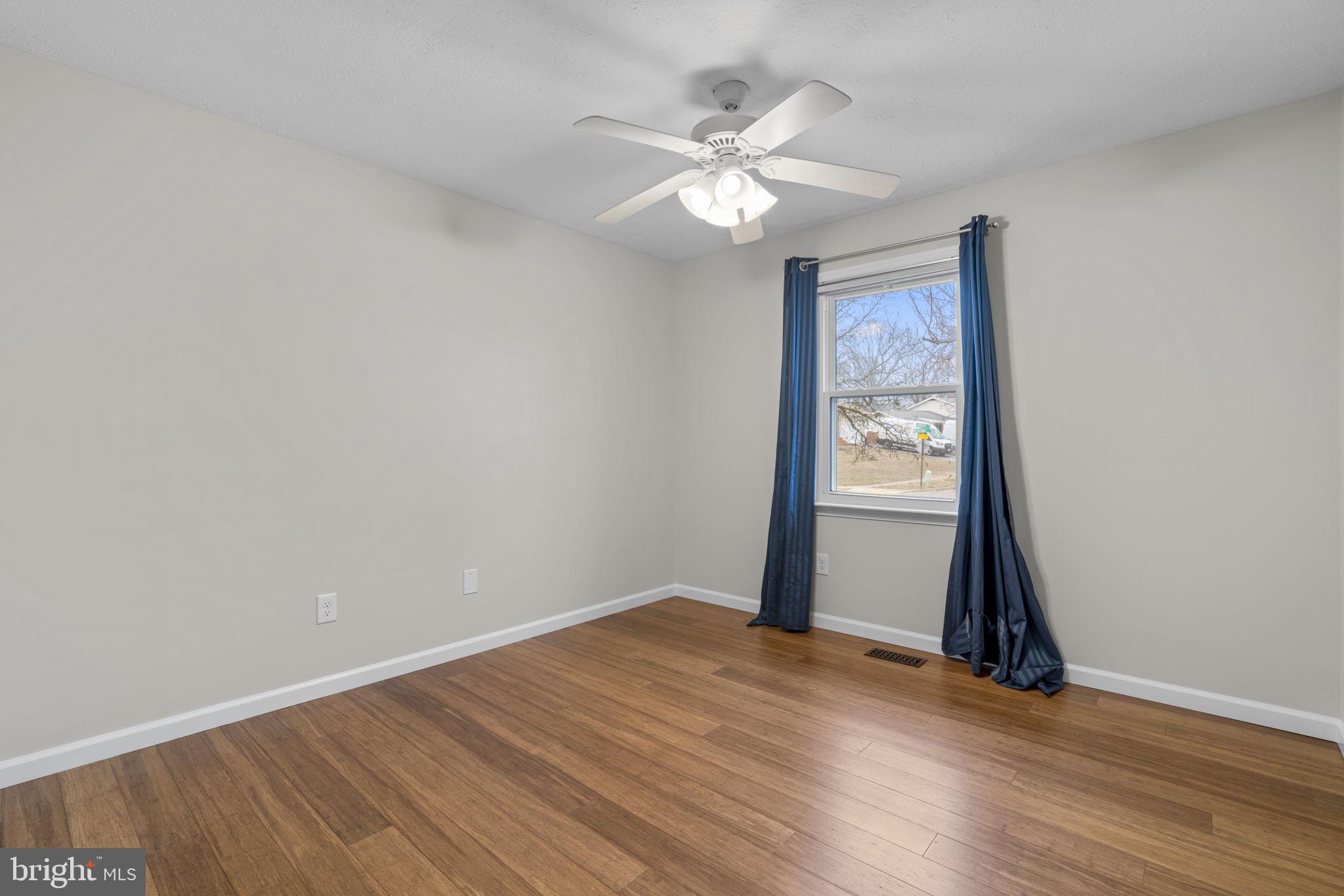 7818 Metacomet Road Hanover, MD 21076 - Photo 28 of 52 a view of an empty room with wooden floor and a window