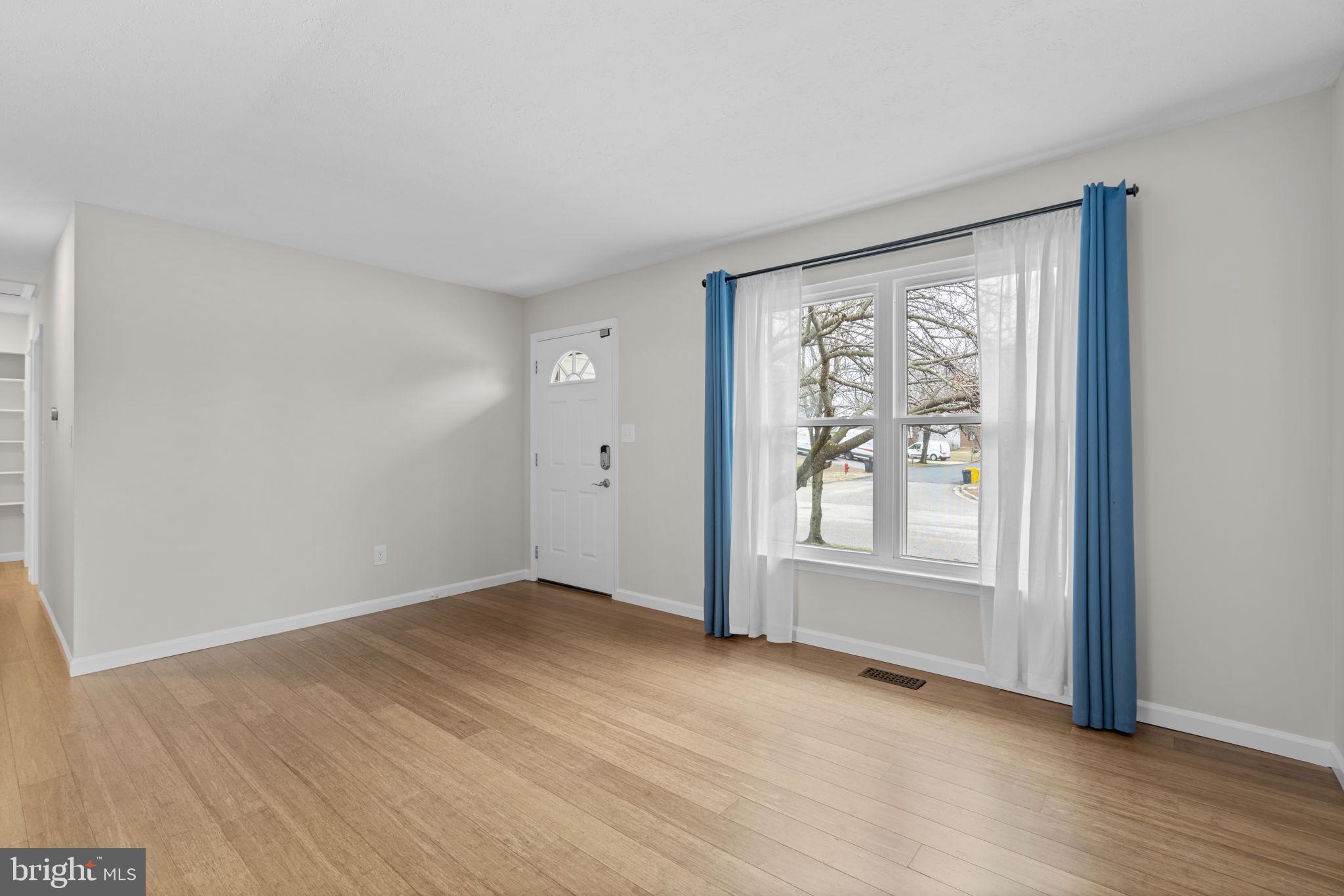 7818 Metacomet Road Hanover, MD 21076 - Photo 5 of 52 an empty room with wooden floor and windows