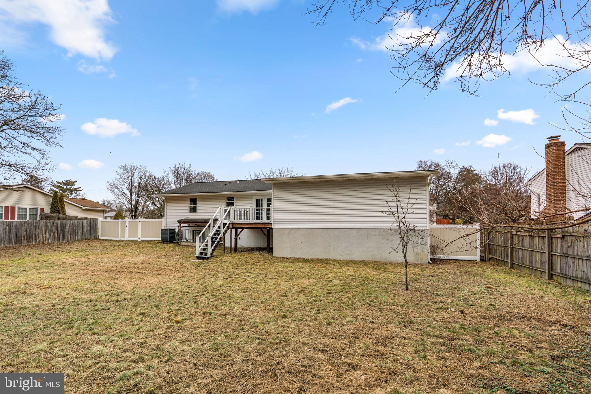 7818 Metacomet Road Hanover, MD 21076 - Photo 51 of 52 a view of a backyard with table and chairs with wooden fence