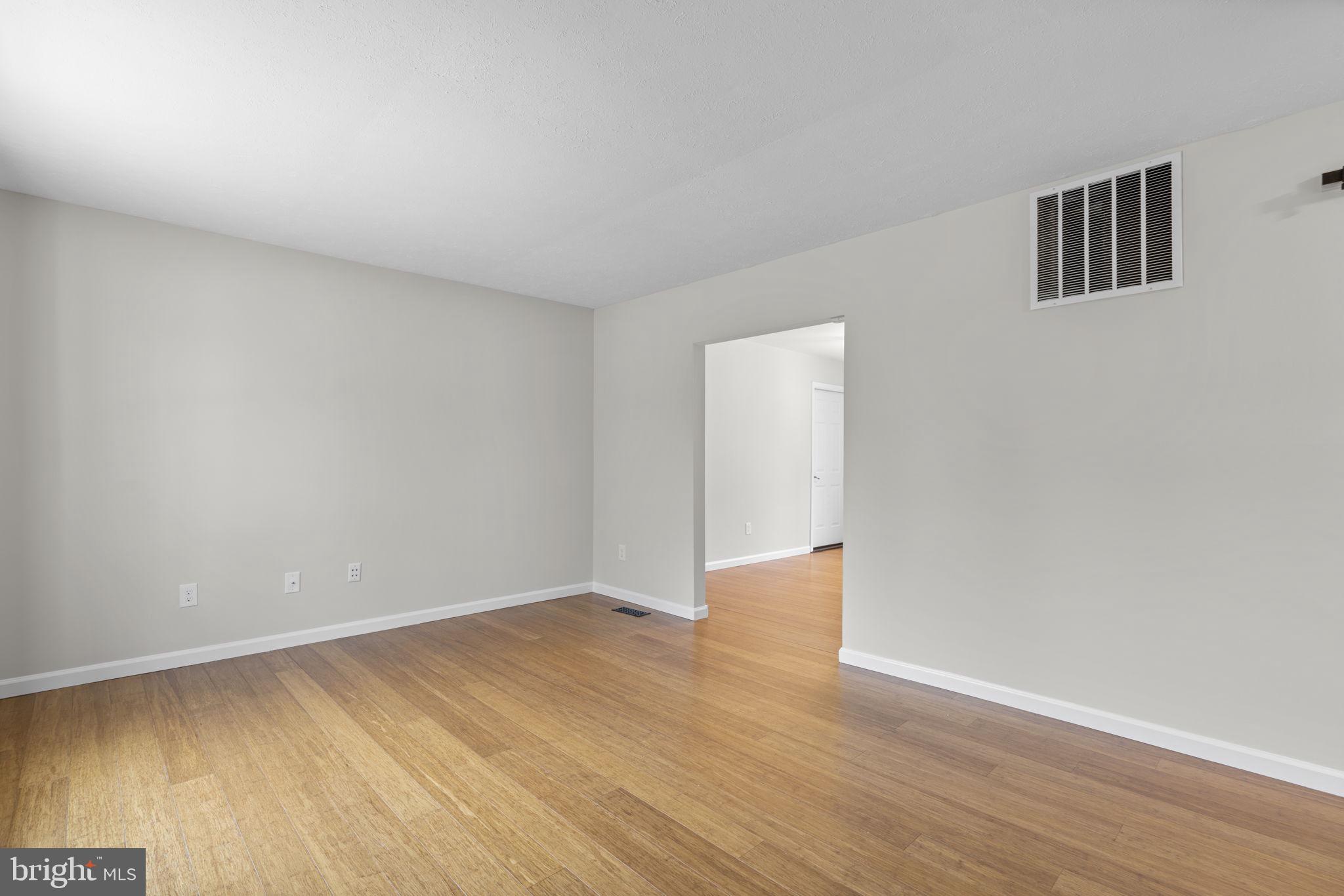 7818 Metacomet Road Hanover, MD 21076 - Photo 6 of 52 a view of an empty room with wooden floor