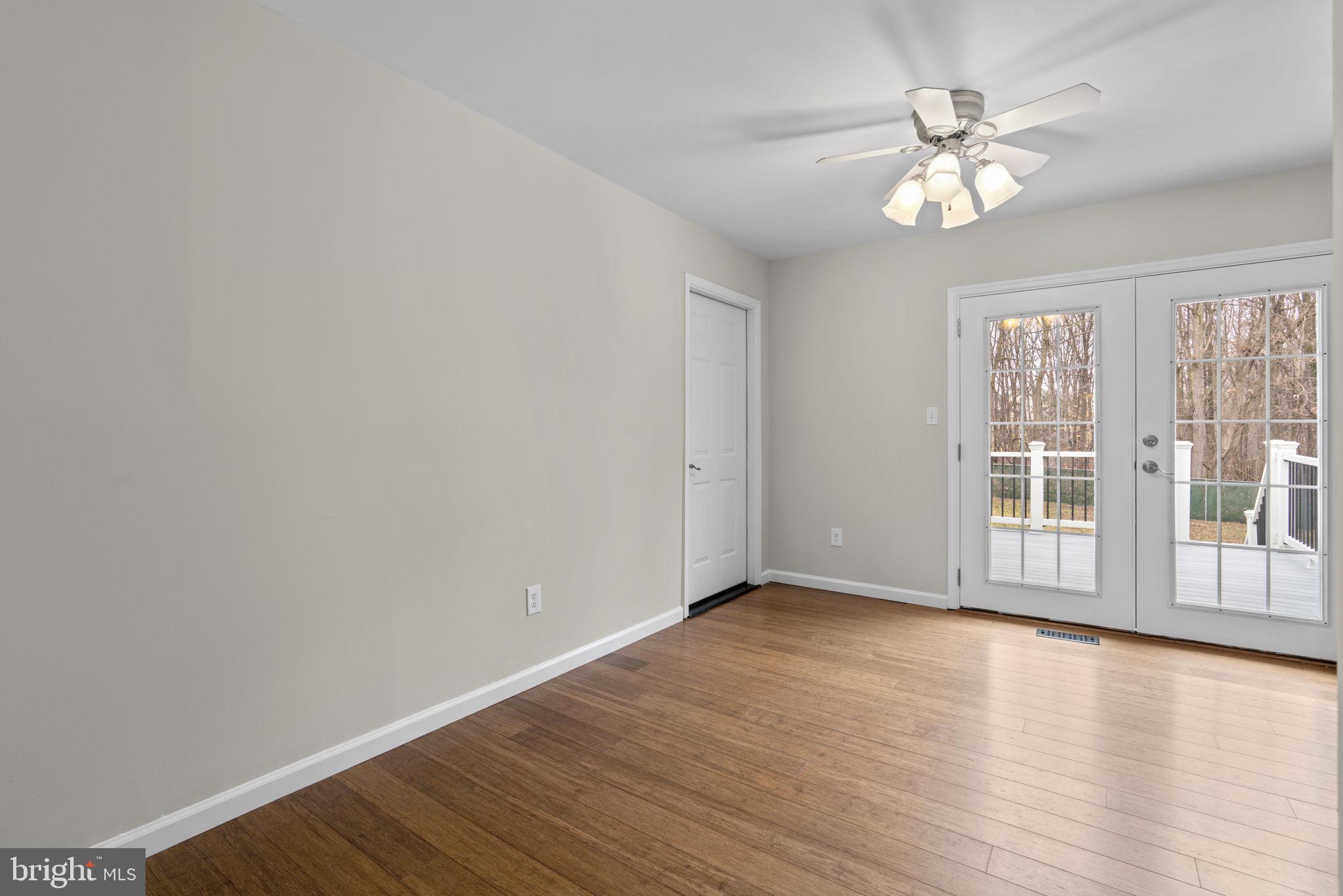7818 Metacomet Road Hanover, MD 21076 - Photo 8 of 52 a view of an empty room with wooden floor and a window